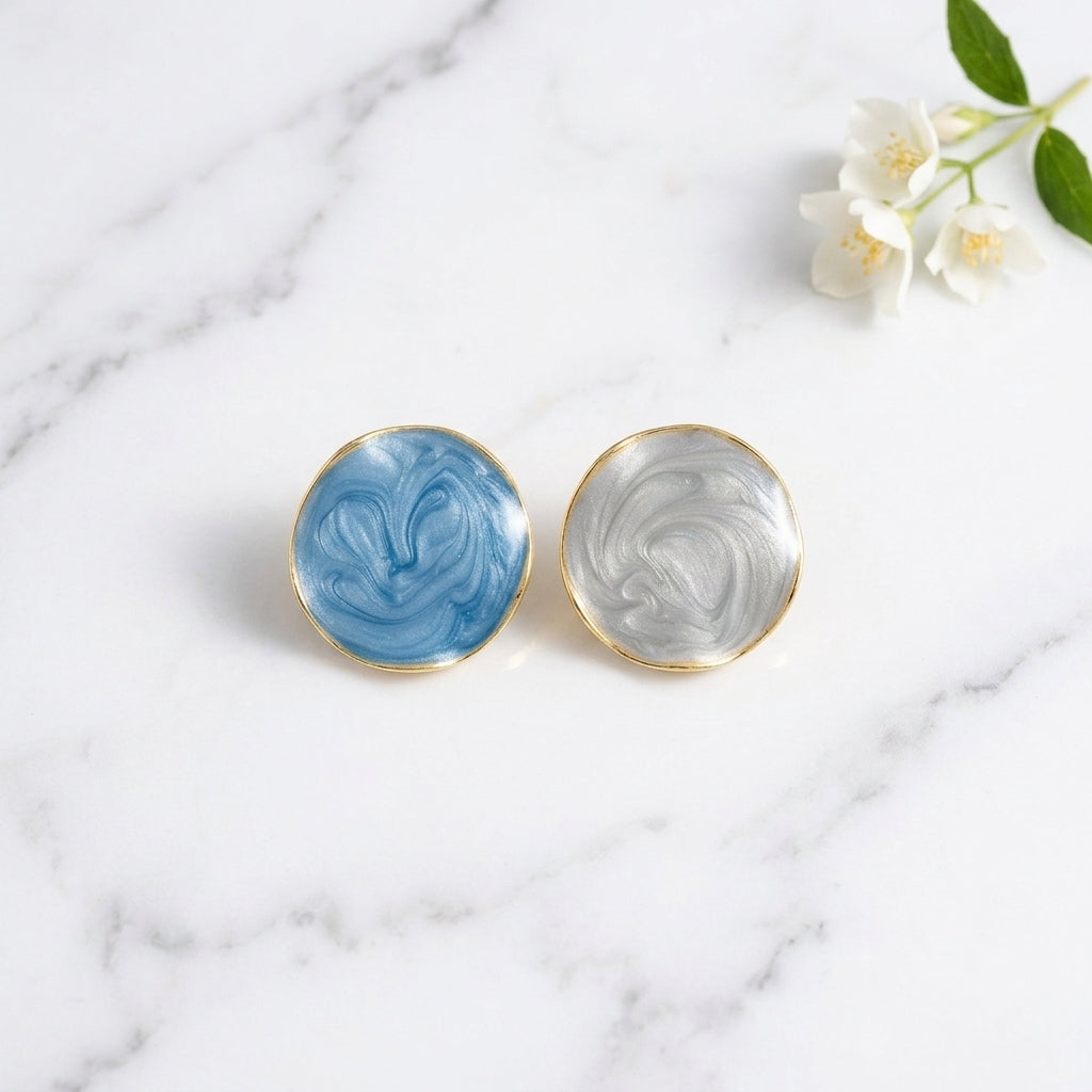 Blue and white marble swirl stud earrings with gold-tone frame