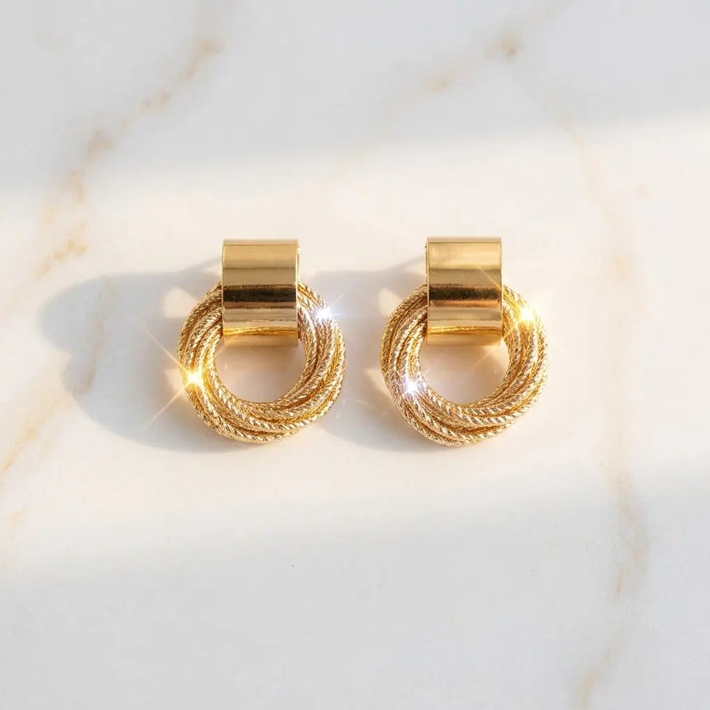 a glowing golden earring placed on a marble surface