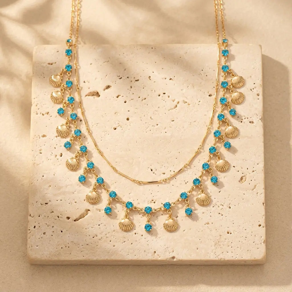 blue stones and shells hanging on gold chain